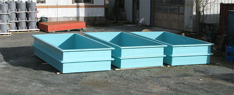Three light blue Dura-Tech fiberglass rectangular lobster tanks with integrated compartments