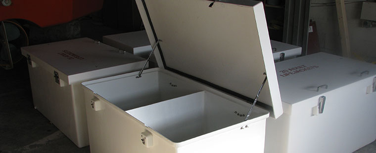 Dura-Tech fiberglass custom storage boxes with hinged lids and latches in manufacturing facility