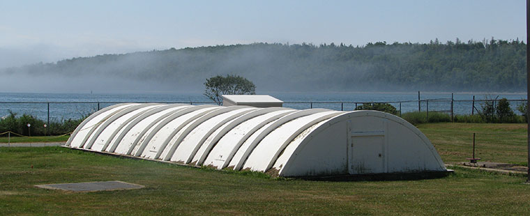 Dura-Tech fiberglass domed cover structure installed in coastal field with water view