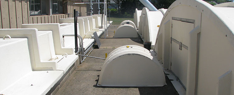 Dura-Tech fiberglass domed covers and tank components displayed at manufacturing facility