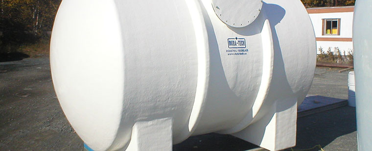 Dura-Tech horizontal fiberglass saddle tank with legs and access port displayed outdoors