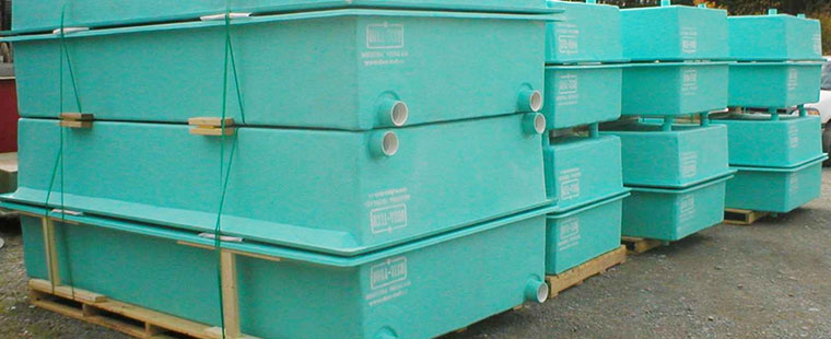 Dura-Tech fiberglass rectangular aquaculture tanks stacked on wooden pallets ready for delivery