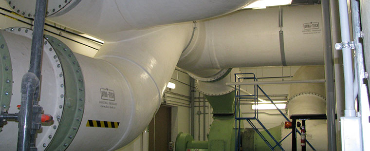 Large fiberglass ventilation duct system with flanged connections in industrial facility