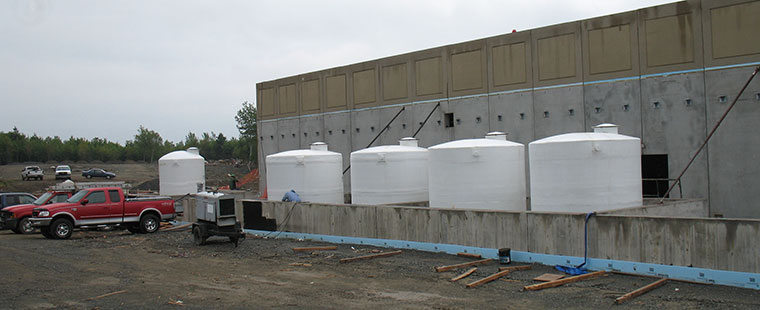 Dura-Tech fiberglass vertical storage tanks installation at industrial facility construction site