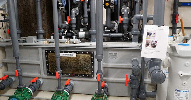 Dura-Tech fiberglass rectangular tank with filtration system and control panel for aquaculture operations